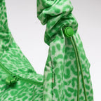 Lieblingstasche Moon Bag Ruffle in green leopard print with a gathered scrunchie-style strap and drawstring detail.