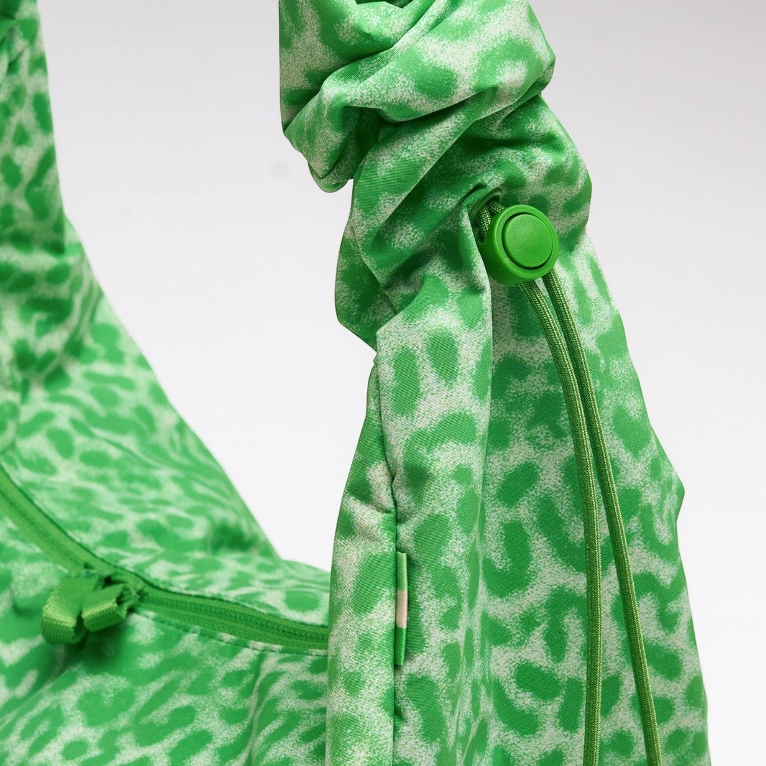 Lieblingstasche Moon Bag Ruffle in green leopard print with a gathered scrunchie-style strap and drawstring detail.