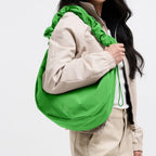 Lieblingstasche Moon Bag Ruffle Large in bright green with a gathered shoulder strap worn by a model