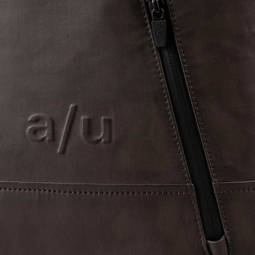 Lieblingstasche a/u by aunts & uncles Hamamatsu backpack detail featuring dark brown coated canvas and zipper pocket