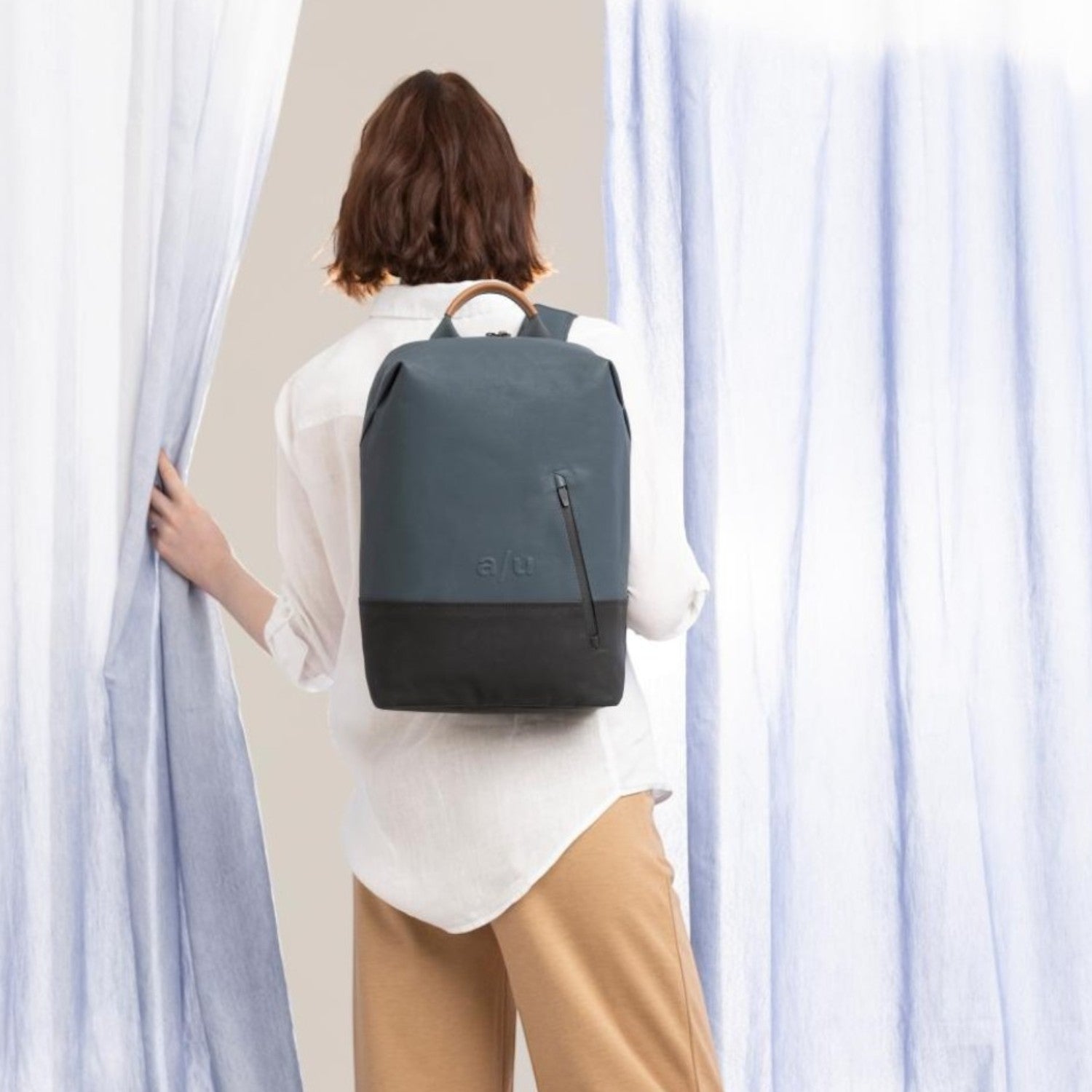 Lieblingstasche a/u by aunts & uncles Hamamatsu backpack in blue and black canvas with leather details on a model