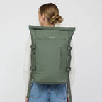 Lieblingstasche Helsinki Pro rolltop backpack in olive green worn by a woman against a plain background