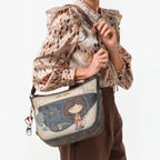 Lieblingstasche cross-body bag featuring a whimsical illustrated girl design and decorative charm on a shoulder strap
