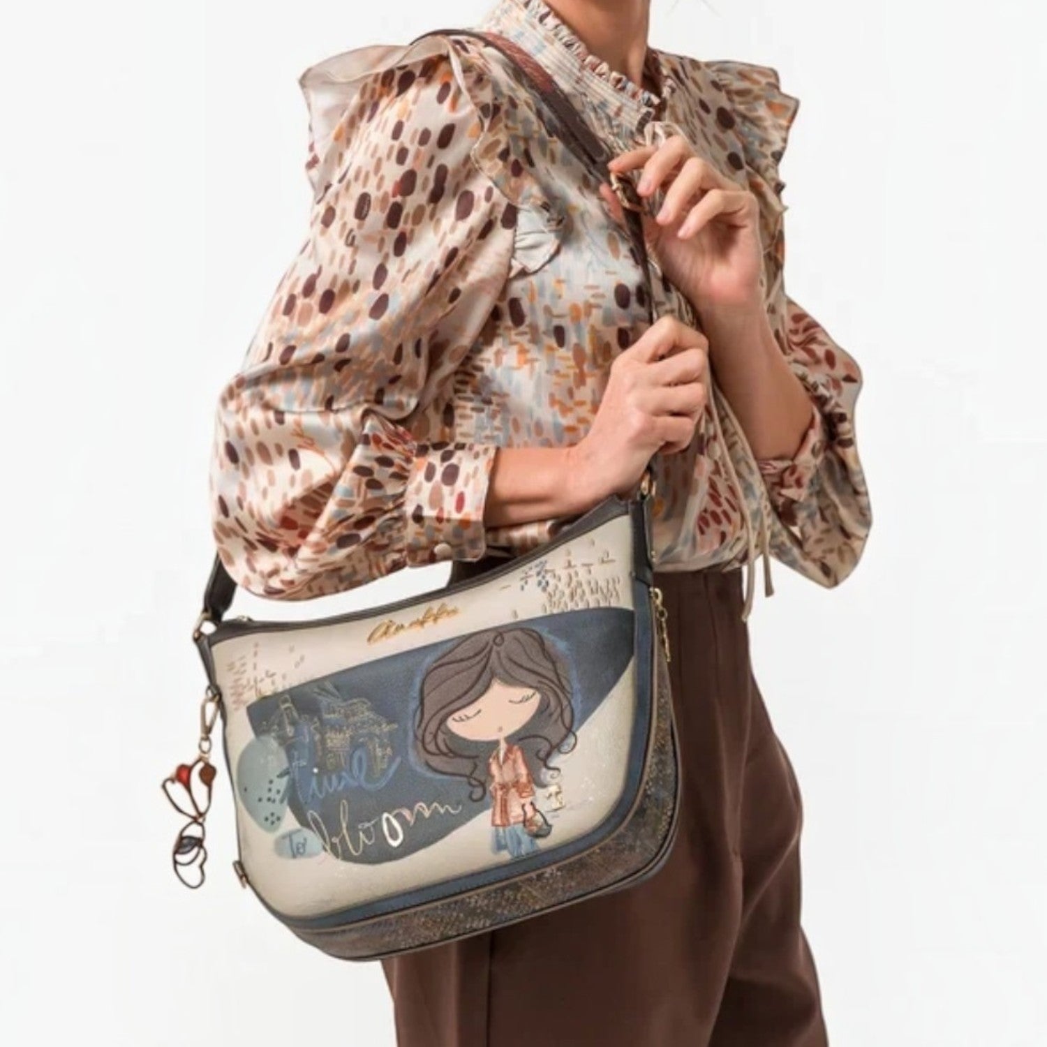 Lieblingstasche cross-body bag featuring a whimsical illustrated girl design and decorative charm on a shoulder strap