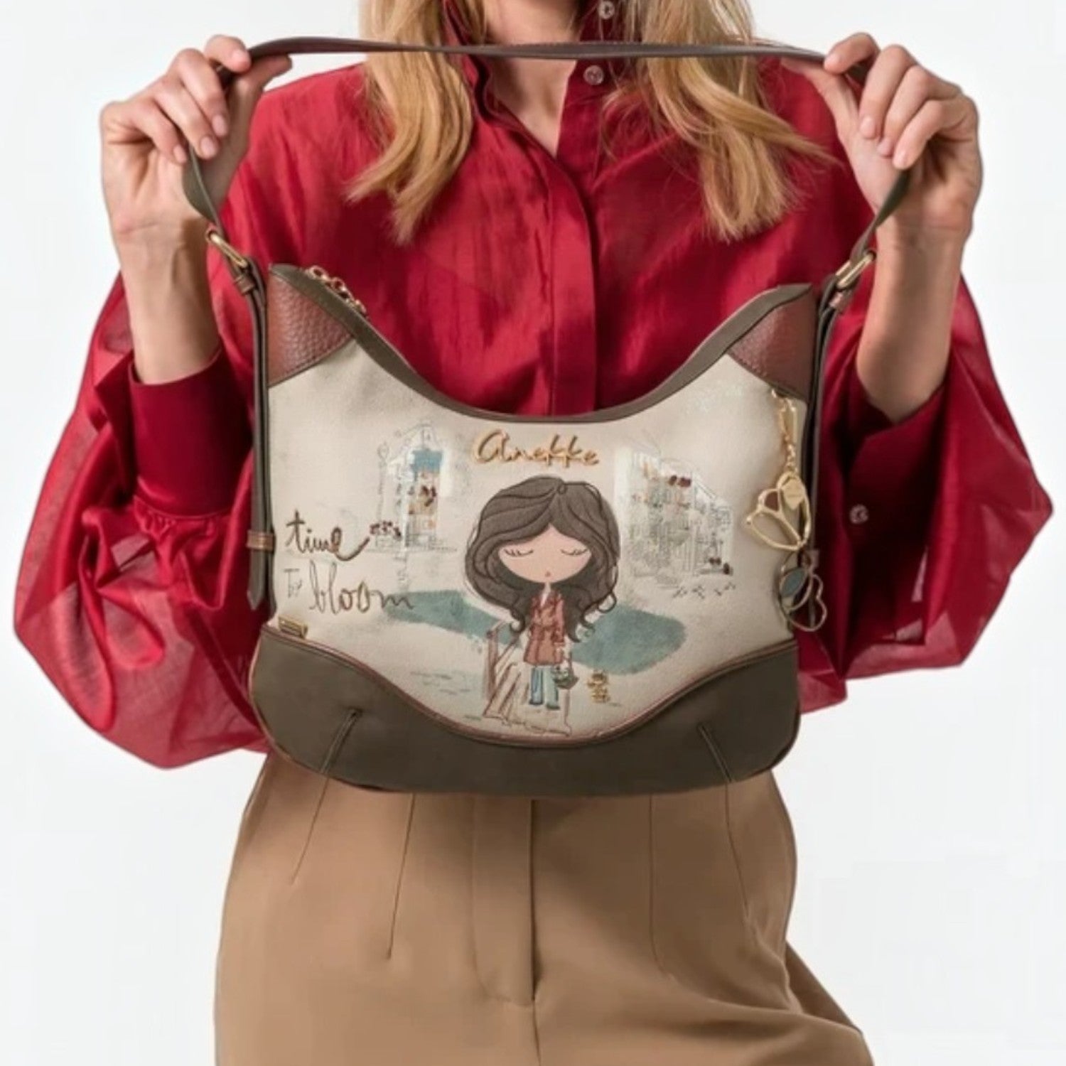 Lieblingstasche shoulder bag with whimsical illustration, cream and olive green accents, held by a woman.