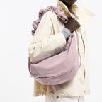 Lieblingstasche large mauve moon bag with a ruffled shoulder strap worn over the shoulder by a model