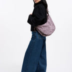 Lieblingstasche Moon Bag Ruffle in large size with a pink and black leopard print pattern worn over the shoulder.