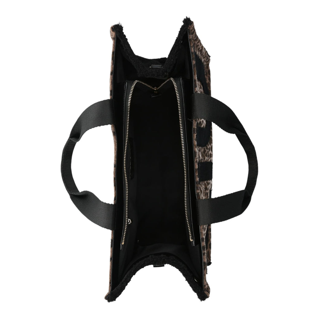 Lieblingstasche Tote Animalier L featuring a leopard print faux fur exterior and black fabric handles, top view.