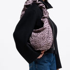 Lieblingstasche Moon Bag Ruffle in leopard print with a gathered shoulder strap worn by a model