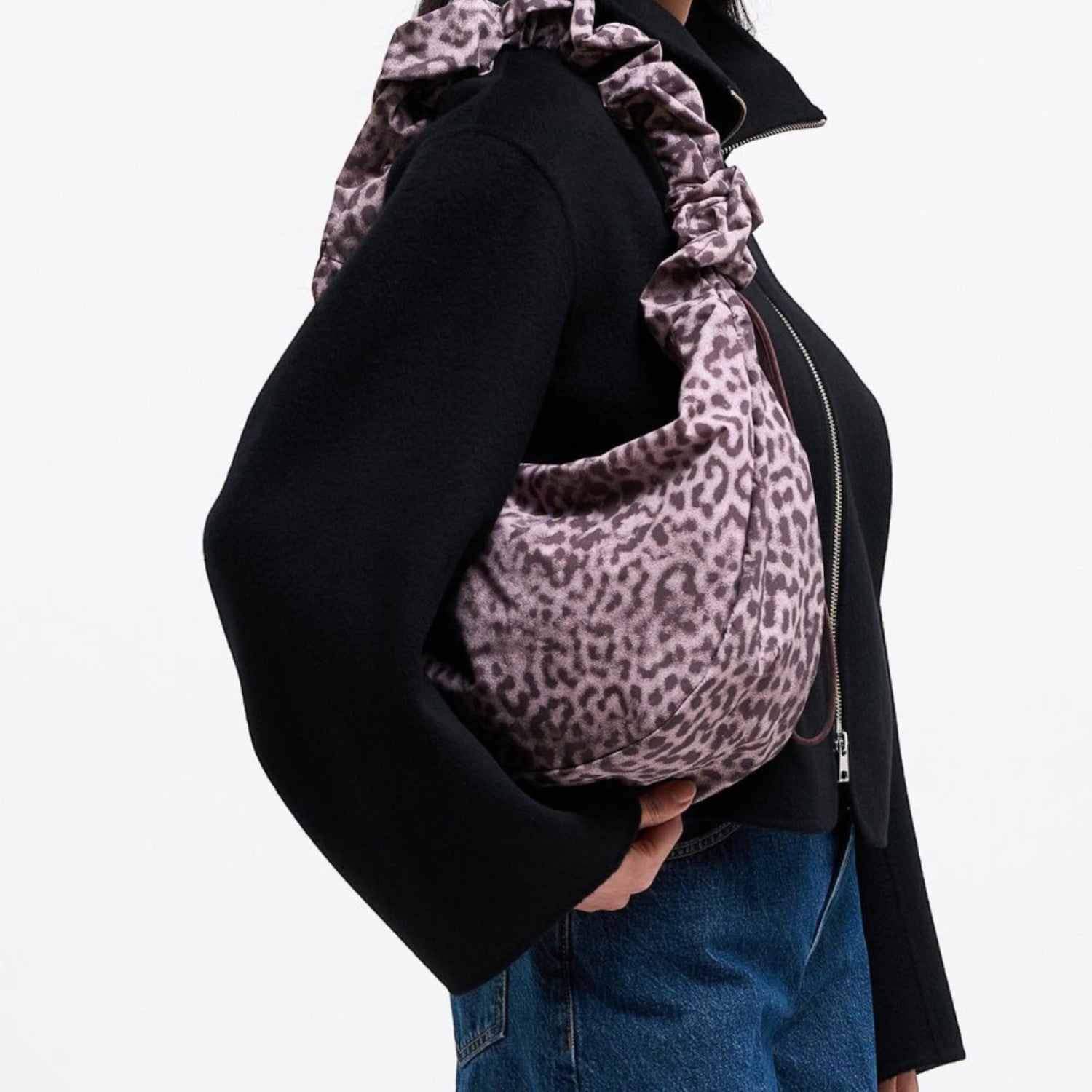 Lieblingstasche Moon Bag Ruffle in leopard print with a gathered shoulder strap worn by a model