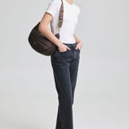 Lieblingstasche Lifetime Buddy M dark brown quilted crossbody bag worn by a woman in a white t-shirt and jeans