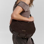 Lieblingstasche Lifetime Sister suede shoulder bag in dark brown with gold hardware worn by a woman