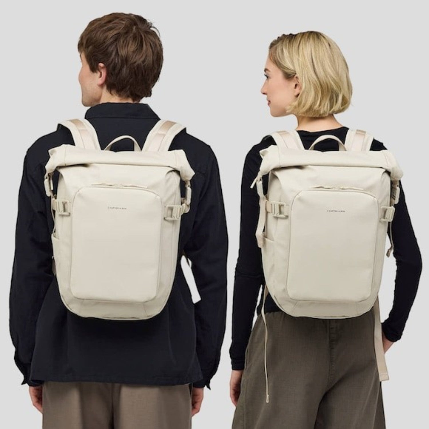 Lieblingstasche Lisbon Small beige roll-top backpack worn by a man and woman for travel and daily use