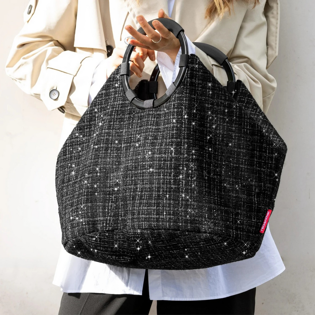Lieblingstasche Loopbag Hobo in black textured fabric with sparkling glitter details and round black handles.