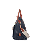 Lieblingstasche Lucia M navy blue leather handbag with brown trim and adjustable strap.