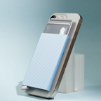 Lieblingstasche MagSafe card protector in light blue with white fluted stripes attached to a smartphone