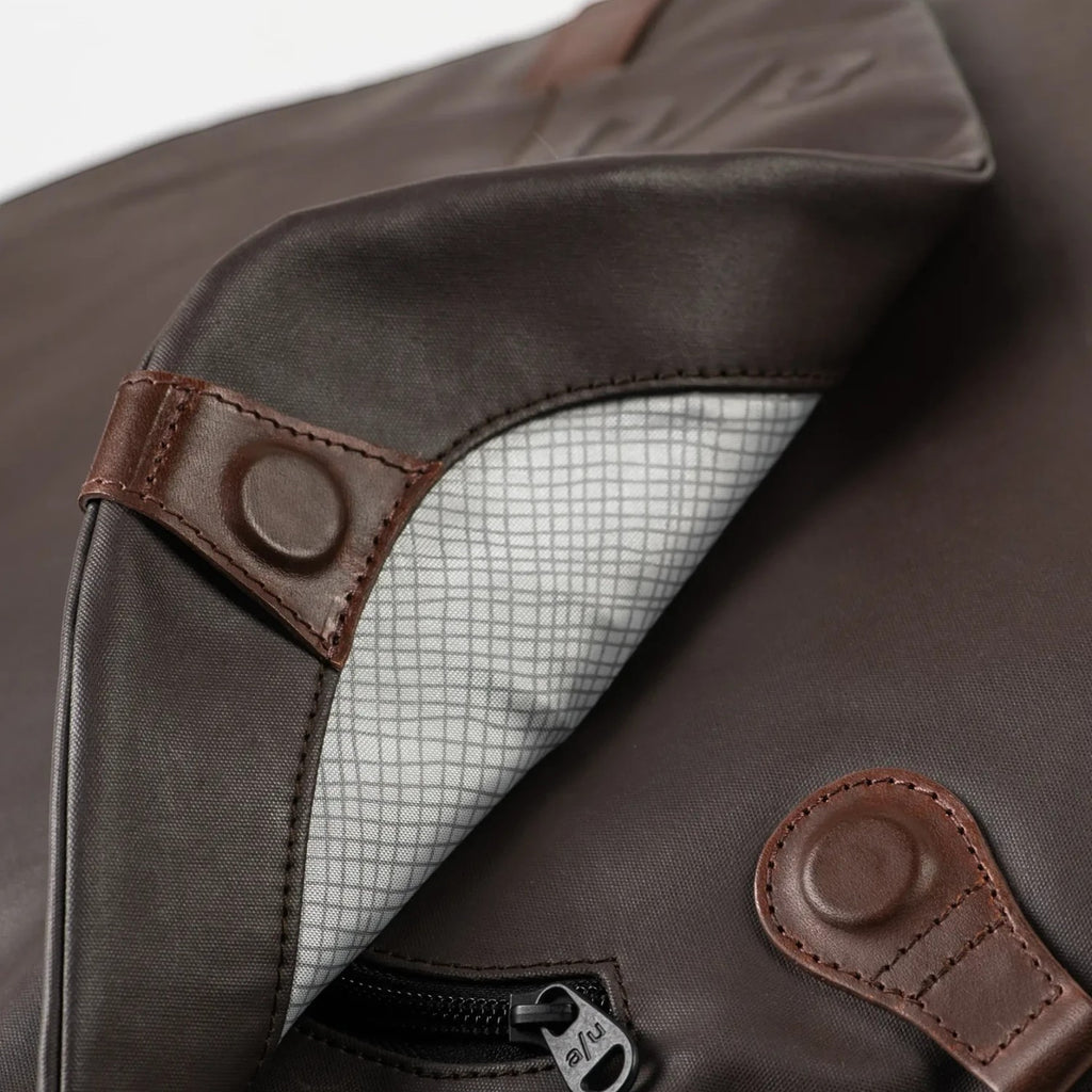 Lieblingstasche Matsumoto dark brown bag with brown leather accents and a grey grid-patterned interior lining