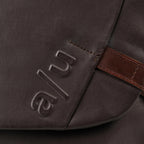 Close-up of the Lieblingstasche Matsumoto bag in dark brown fabric with embossed a/u logo and brown leather detail