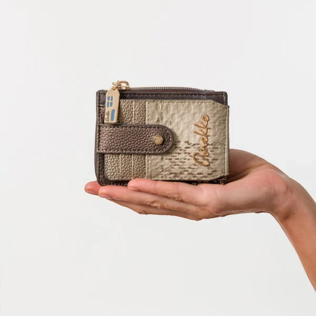 Lieblingstasche card holder in metallic bronze and beige textured leather held in a hand