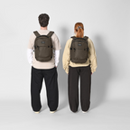 Lieblingstasche eoto Midi20 city backpack in olive green worn by a man and a woman on a light grey background