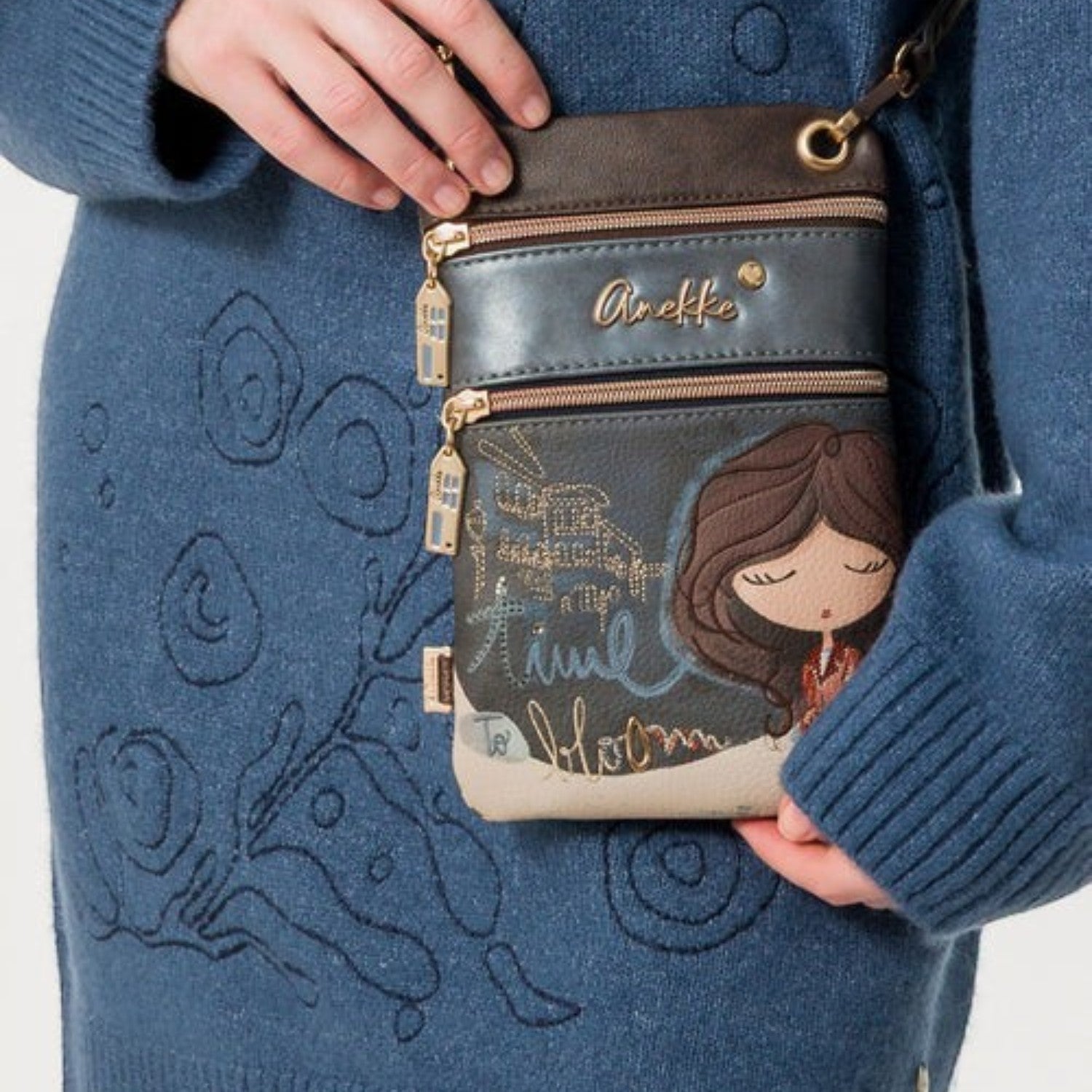Lieblingstasche mini cross-body bag featuring Anekke illustration, metallic accents, and multiple zippered pockets.