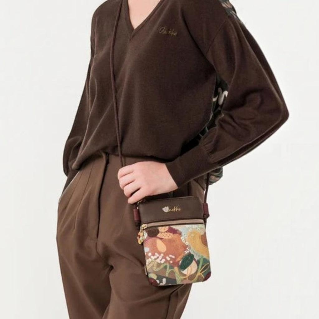 Lieblingstasche mini cross-body bag with floral pattern and brown trim worn by a woman in a brown sweater
