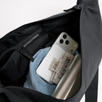 Lieblingstasche GOT BAG Moon Bag Large in black showing the spacious interior with a zippered pocket and accessories