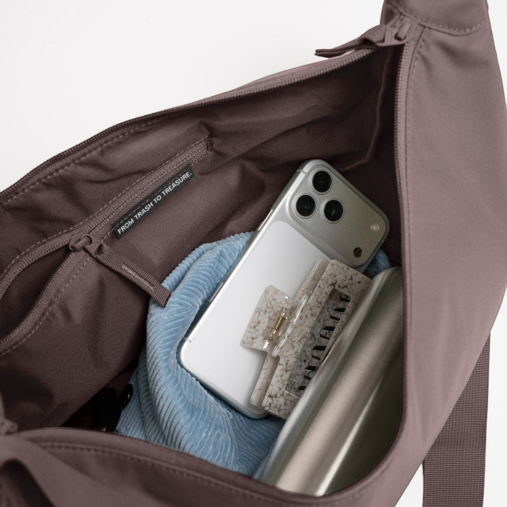 Lieblingstasche Moon Bag Large in mauve showing the spacious interior with a smartphone and accessories inside