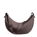 Lieblingstasche Moon Bag Large in a muted mauve tone with an adjustable crossbody strap and crescent silhouette