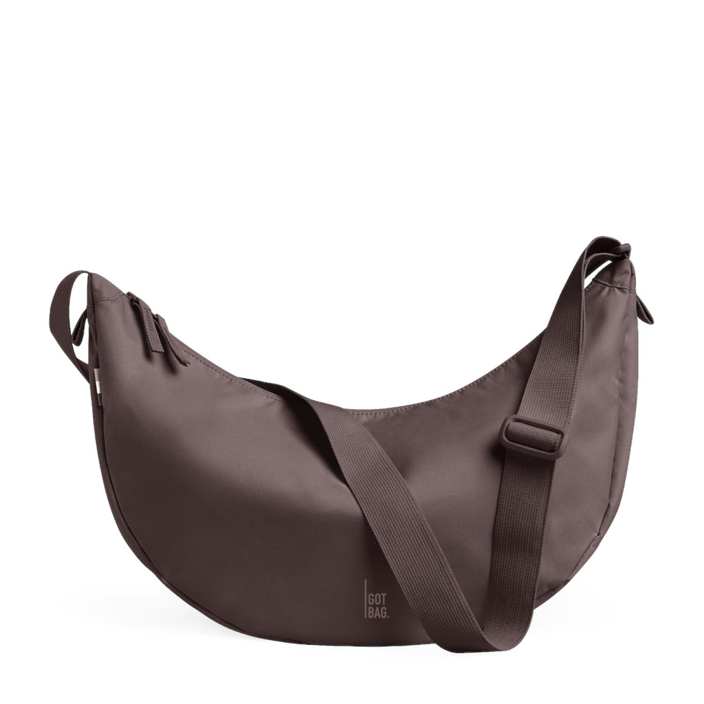 Lieblingstasche Moon Bag Large in a muted mauve tone with a crescent shape and adjustable shoulder strap