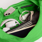 Lieblingstasche Moon Bag Ruffle Large in bright green, showing the spacious interior filled with daily essentials.