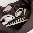 Lieblingstasche Moon Bag Ruffle Large in dark brown, showing interior organization with tech accessories and notebook.