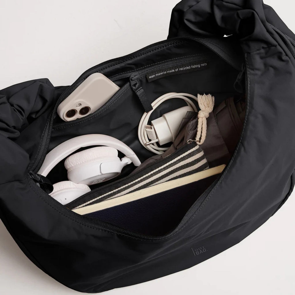 Lieblingstasche Moon Bag Ruffle Large in black, showing the spacious interior with organized accessories and zipper pocket