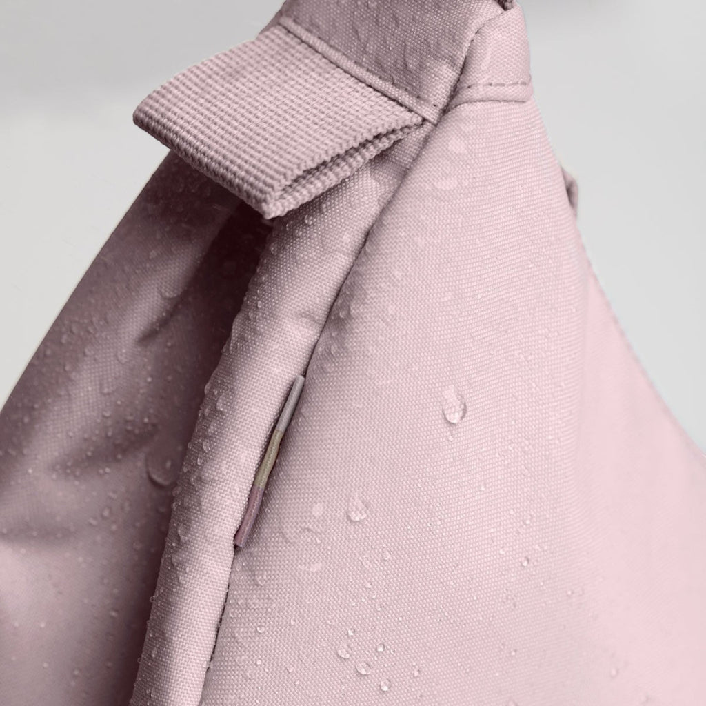 Lieblingstasche Moon Bag Small in dusty pink with water-repellent fabric texture and close-up detail of strap