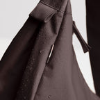 Lieblingstasche Moon Bag Large in dark brown water-resistant fabric with visible water droplets on the surface