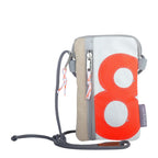 Lieblingstasche Nautik Lütt recycled sailcloth phone bag with orange number 8 graphic and grey strap.