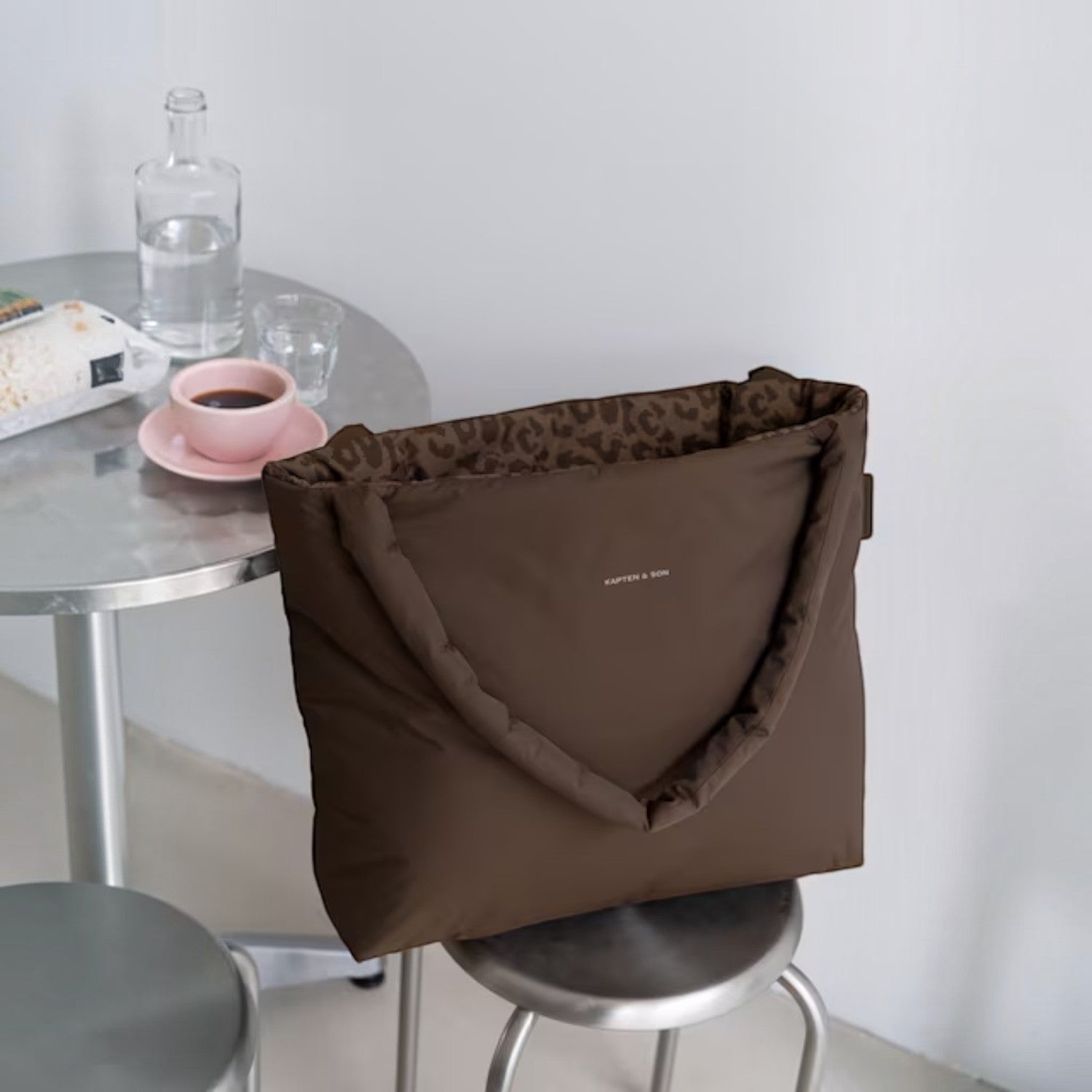 Lieblingstasche Norva 2in1 reversible shopper bag in brown with leopard print lining on a stool