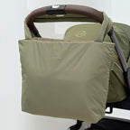 Lieblingstasche Norva 2in1 reversible shopper bag in sage green attached to a stroller handle