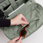 Lieblingstasche Pro Pack sage green backpack interior with organized compartments, laptop sleeve, and sunglasses.