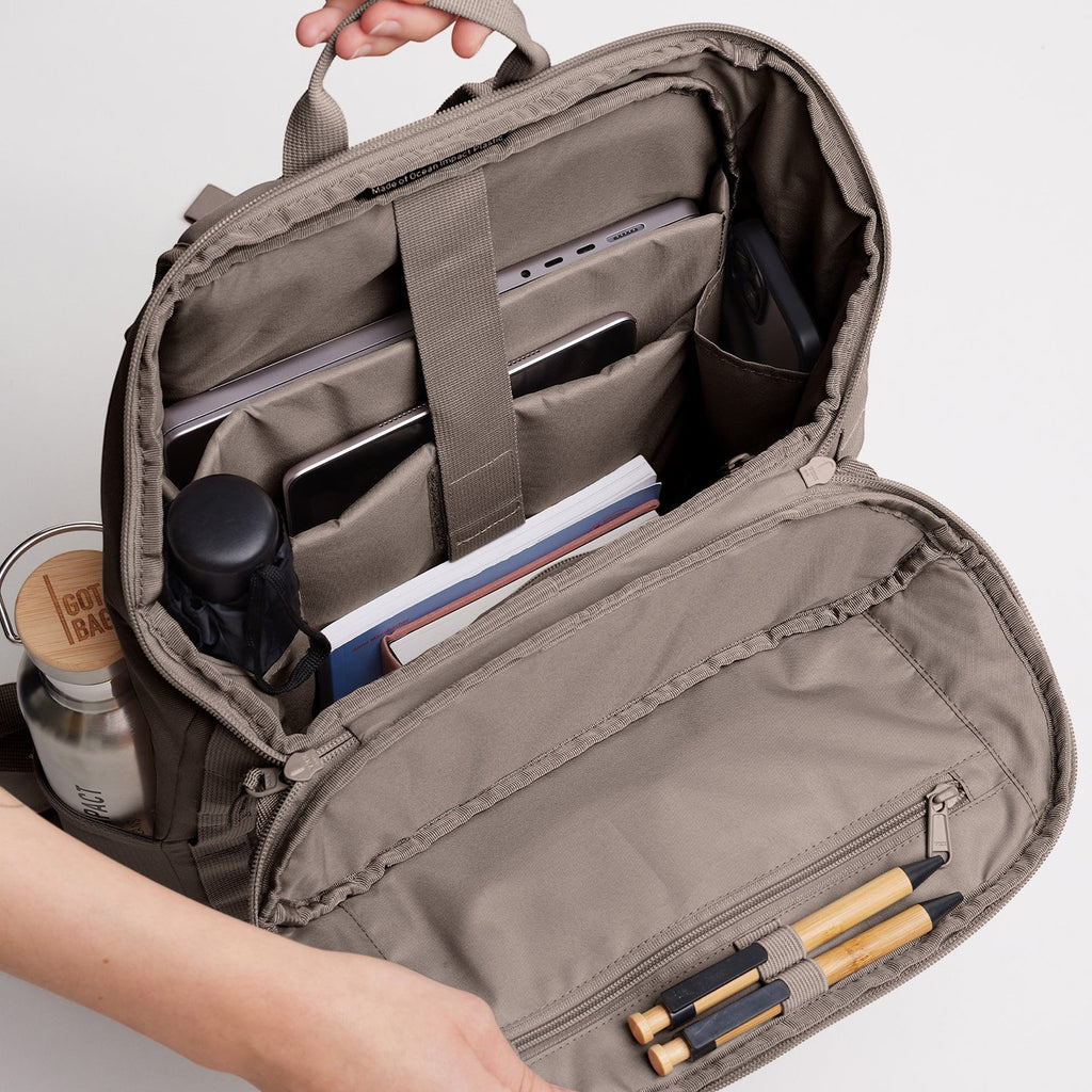Lieblingstasche Pro Pack backpack interior with laptop, tablet, phone, books, water bottle, and pens. Taupe fabric.