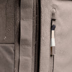 Lieblingstasche Pro Pack backpack in taupe canvas with water droplets, featuring adjustable straps and a zip pocket.