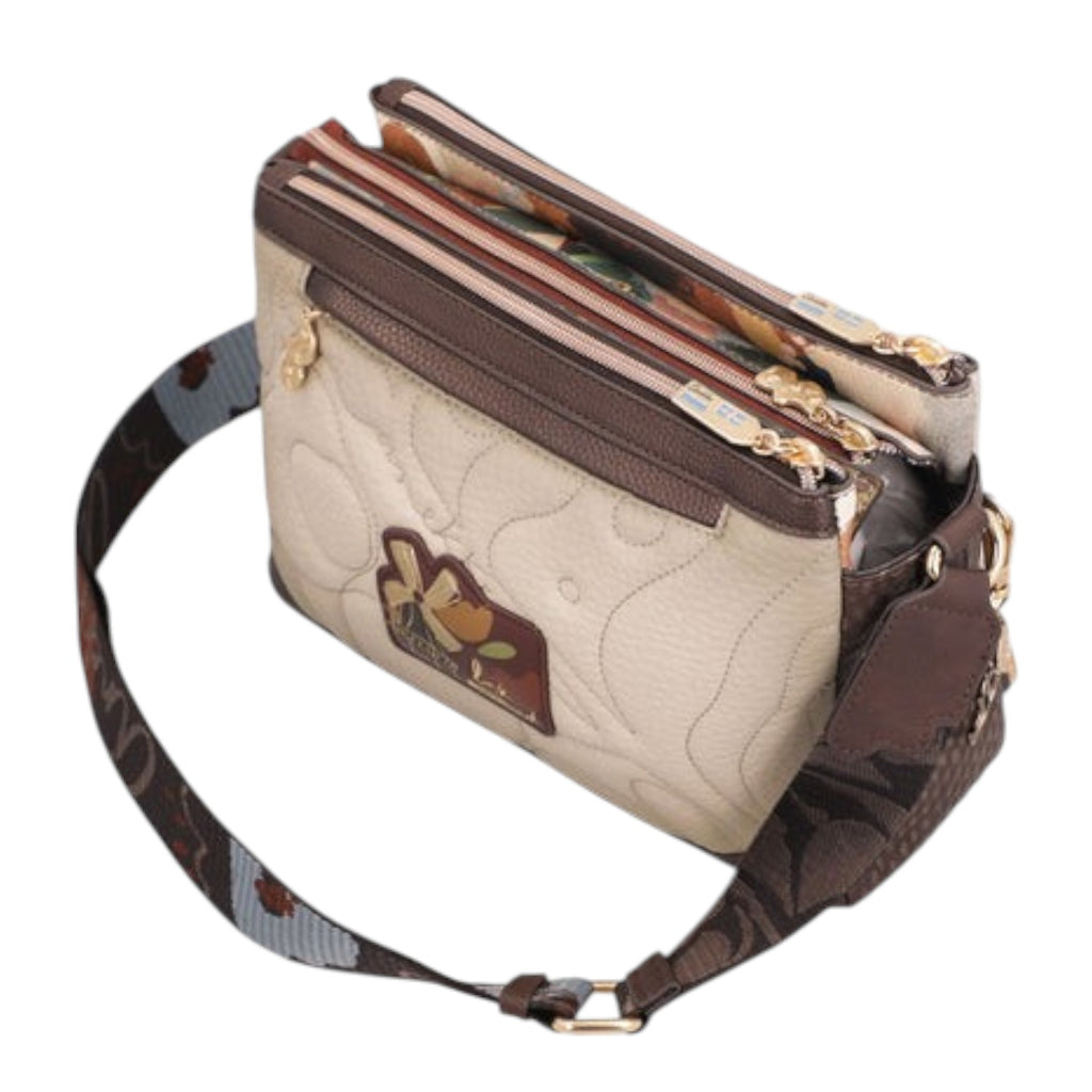 Lieblingstasche quilted beige cross-body bag with brown leather trim, multiple zippered compartments, and patterned strap