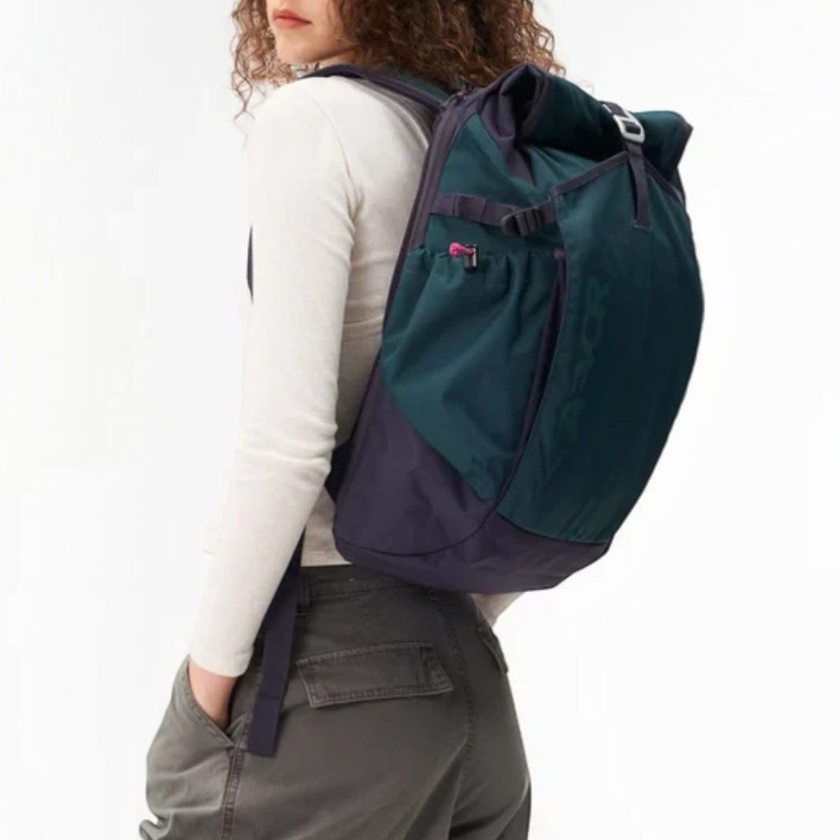 Lieblingstasche Roll Pack 2.0 backpack in dark green and navy with rolltop closure worn by a woman
