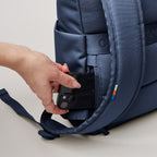 Lieblingstasche Rolltop Easy Small navy blue backpack with a side pocket holding a smartphone.