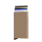 Lieblingstasche Secrid Cardprotector in metallic gold with cards sliding out for quick access and RFID protection.