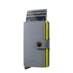 Lieblingstasche Secrid Miniwallet Matte in grey leather with a lime green card protector and snap button closure
