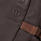 Close-up of the Lieblingstasche Sendai bag in dark brown synthetic fabric with embossed logo and brown leather strap
