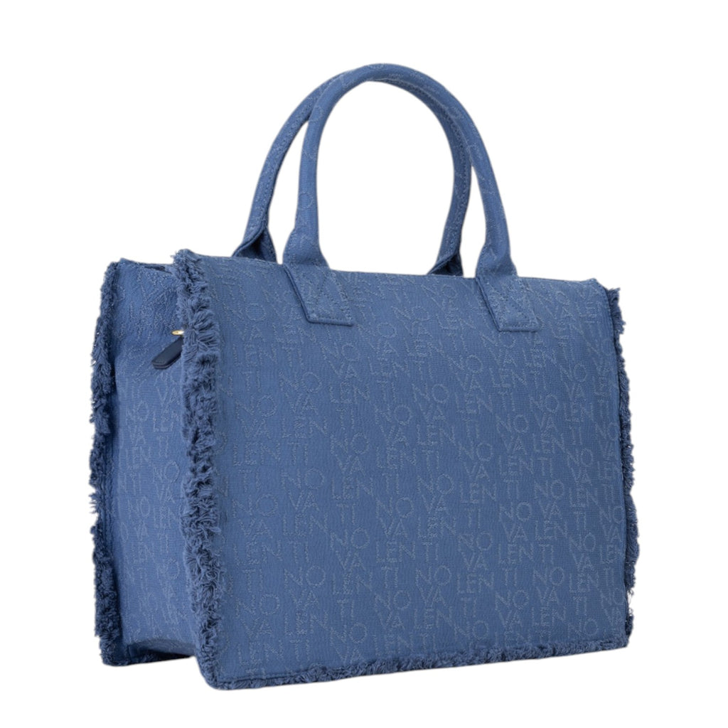 Lieblingstasche Shyla blue denim tote bag with frayed edges and all-over logo pattern.