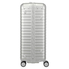 Lieblingstasche silver aluminium trolley suitcase with ribbed texture, leather handles, and four wheels.