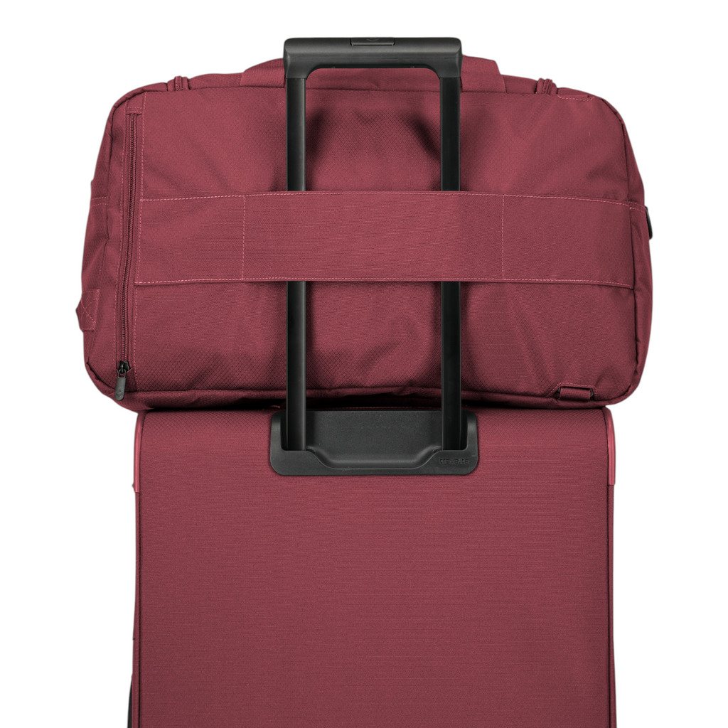 Lieblingstasche Skaii weekender bag in burgundy attached to a matching suitcase handle for easy travel.